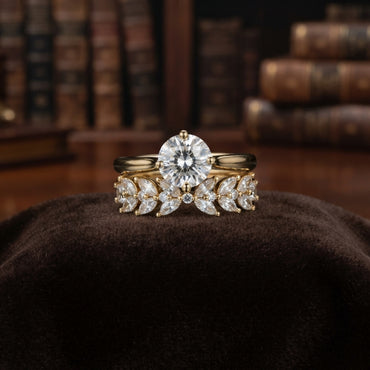 Gold Solitaire CZ & Marquise Wheat Band Bridal Stackable Ring Set on dark brown velvet ring cushion with vintage books backdrop