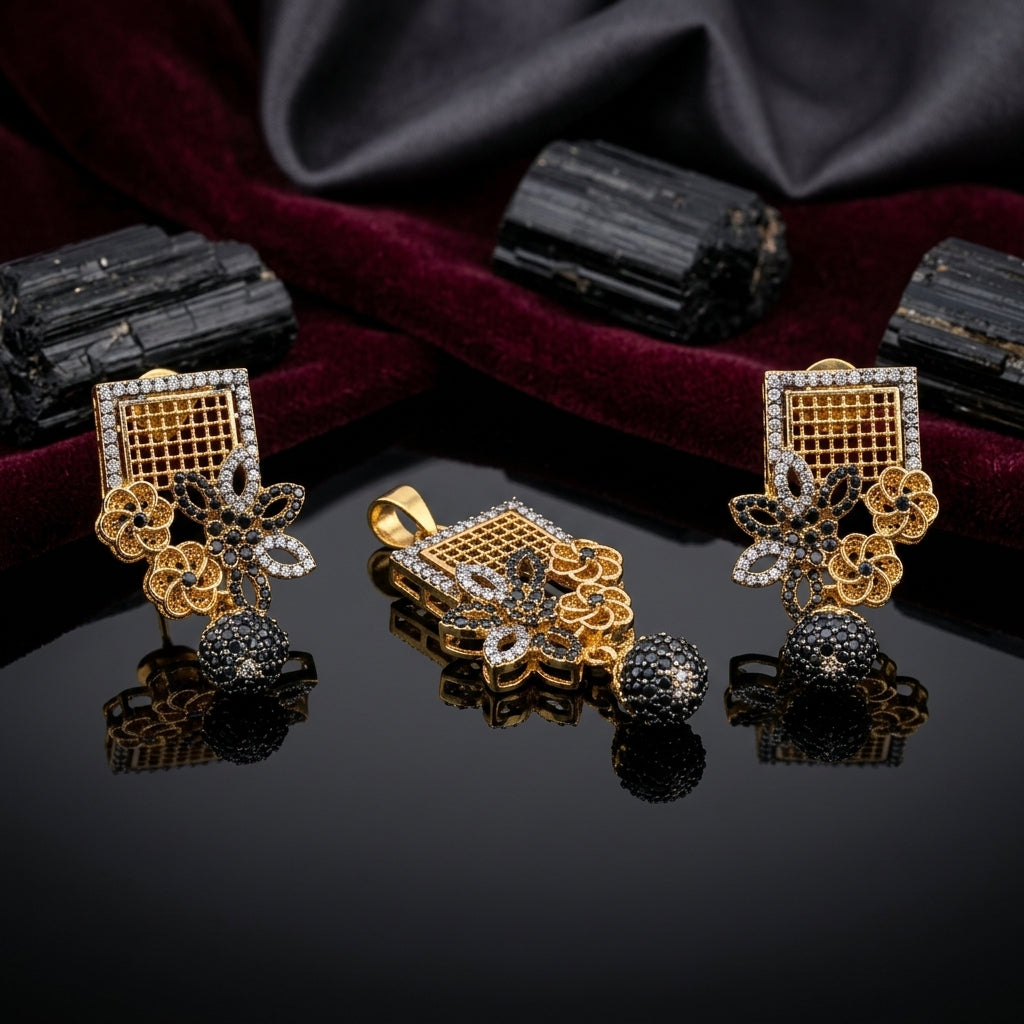 Gold-Tone Square Grid Black CZ Floral Jhumka Pendant & Earrings Jewelry Set on dark velvet surface with black tourmaline stones