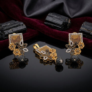 Gold-Tone Square Grid Black CZ Floral Jhumka Pendant & Earrings Jewelry Set on dark velvet surface with black tourmaline stones