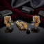 Gold-Tone Square Grid Black CZ Floral Jhumka Pendant & Earrings Jewelry Set on dark velvet surface with black tourmaline stones