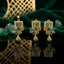 Gold-Tone Square Grid Green CZ Floral Jhumka Pendant & Earrings Jewelry Set on emerald green velvet with raw emerald stones