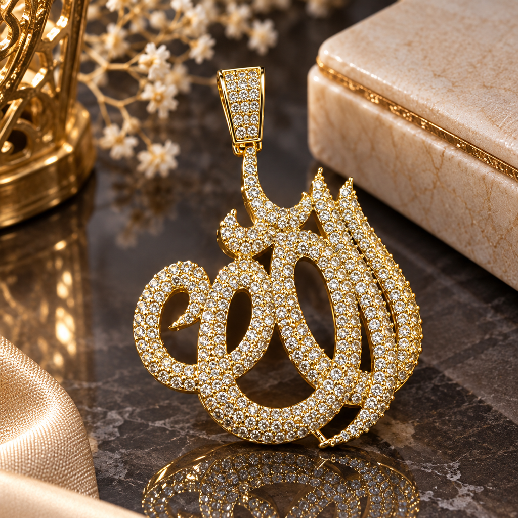 Gold-tone Allah calligraphy-shaped pendant with closely arranged clear accents and a rectangular embellished hanging loop.