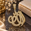 Gold-tone Allah calligraphy-shaped pendant with closely arranged clear accents and a rectangular embellished hanging loop.
