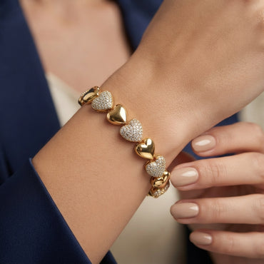 Gold-Tone Alternating CZ Pavé & Polished Heart Tennis Bracelet worn by model in navy blazer