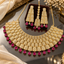 Gold-tone American diamond bridal necklace with rectangular panels and deep pink teardrop accents, matching long earrings and maang tikka.
