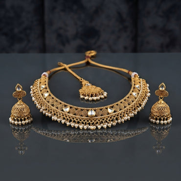 Gold-Tone Antique Kundan Spiral Choker Necklace, Jhumka Earrings & Maang Tikka Set flat lay