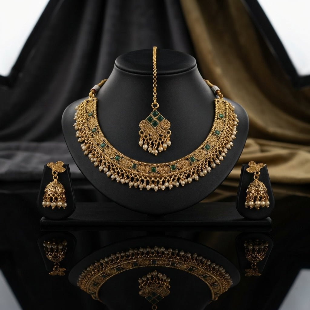 Gold-Tone Antique Rajwari Spiral Choker Necklace, Jhumka Earrings & Maang Tikka Set on display stand