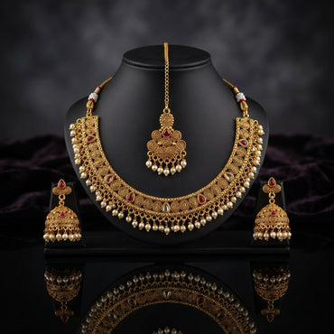 Gold-Tone Rajwari Ruby Stone Choker Necklace, Jhumka Earrings & Chandbali Maang Tikka Bridal Set on stand