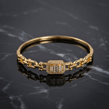 Gold-Tone Baguette & Round CZ Rectangular Charm Chain Link Bangle Bracelet product shot on black marble surface