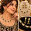 Collage showing a model wearing a gold-tone black-and-clear accent necklace set, alongside a bust display and close-up of the earrings.
