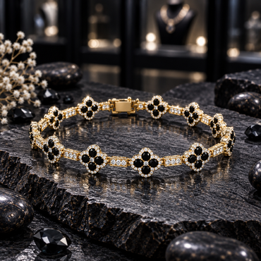 Gold-tone bracelet with black four-petal clover motifs, clear halo borders, rectangular clear-accent links and a rectangular back closure section, arranged on dark slate.