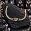 Gold-tone bracelet with two facing black-panel swans, clear-accent necks and borders, and rows of clear rectangular accents.