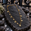 Gold-tone fine chain necklace with flat butterfly charms, round clear accents in circular settings, small bead details, a lobster-style clasp and extension chain, displayed on dark slate.