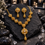 Gold-tone necklace and matching earrings with clear-accent floral motifs, alternating openwork and textured round links, and textured teardrop drops.