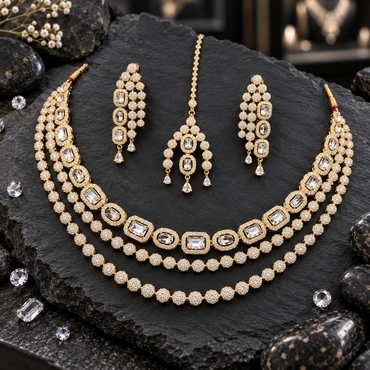Gold-tone three-row necklace with clear-looking rectangle and oval halo links above two floral-cluster rows, matching drop earrings and a bindia.