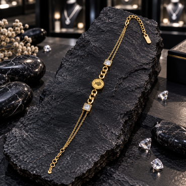Gold-tone bracelet with a round coin-style centrepiece, larger interlocking links, two square clear sparkling accents and fine double-chain sides.