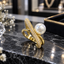 Gold-Tone Crossover Ring with Round Pearl-Look Detail & Curved Clear Accent Strip