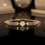 Gold-tone CZ pavé double-row tennis bracelet with white enamel daisy flower charm and yellow center