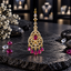 Gold-tone AD bindia with an oval deep pink centre, clear-accent openwork frames, chevron-shaped upper links and five deep pink teardrop drops.