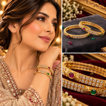 Gold-Tone Double-Row CZ Pave Multi-Color Oval CZ Accent Wide Bangle Pair worn on model wrist in beige embroidered bridal outfit with collage showing close-up on charcoal velvet tray with white gypsophila flowers and macro detail of double row white CZ pave with oval ruby-red and emerald-green CZ accents on gold sunburst divider bangles on burgundy velvet