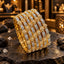 Set of six gold-tone bangles with clear accent-covered rectangular panels, round clear floral clusters and gold-tone borders, displayed together on dark slate.