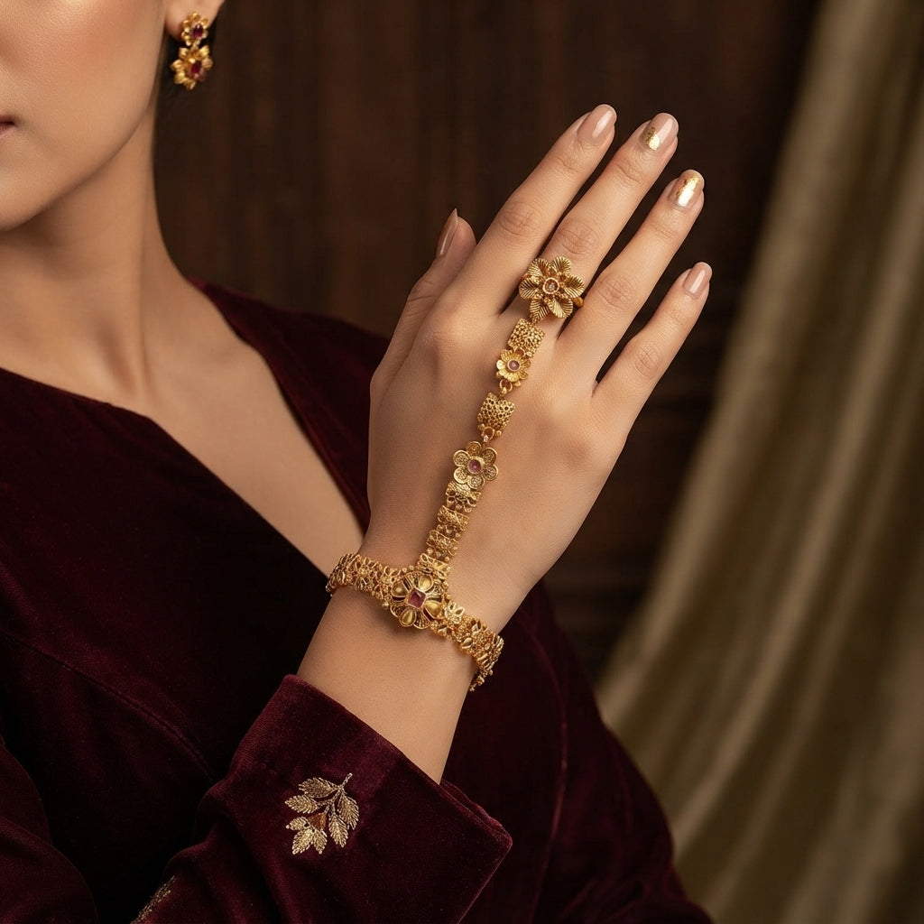 Gold-tone floral hathphool hand harness worn on a hand, showing the linked finger ring and bracelet.