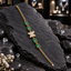 Gold-tone oval-link chain bracelet with a clear-accent butterfly centre, four framed green rectangular accents and a lobster-style clasp.