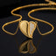 Gold-Tone Half CZ Pavé Rope Twist Heart Pendant Necklace close-up on dark reflective surface