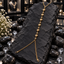 Gold-tone Hand Chain with six bordered heart motifs alternating with round beads, a chain loop at the top and two branching chains below.