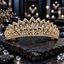 Gold-tone tiara with graduated pointed leaf frames, clear marquise-shaped accents, rainbow-reflective round details and an ornate scrollwork base.