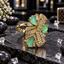 Gold-tone AD ring with three mint-green teardrop-shaped accents, overlapping clear-accent ribbon fan panels and tapered clear details.