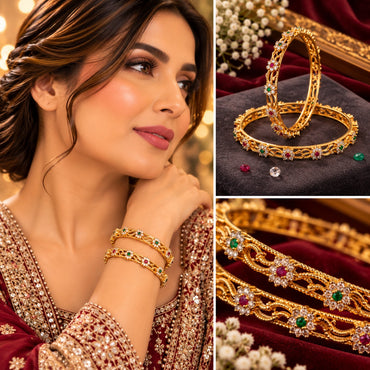 Gold-Tone Multi-Color CZ Floral Scroll Open-Work Slim Bangle Pair worn on model wrist in maroon embroidered bridal outfit with collage showing close-up on charcoal velvet tray with white gypsophila and macro detail of ruby-red CZ center white CZ petal emerald-green CZ side petal floral clusters on gold scroll open-work bangles on burgundy velvet