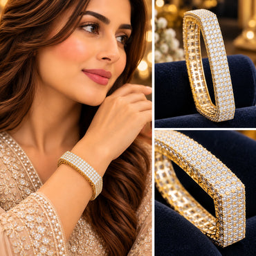 Gold-tone wide multi-row clear accent bangle shown on a model and in close-up views.