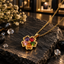 Gold-tone link chain necklace with a flower pendant featuring five heart-shaped accents in purple, red, green, orange and pink around a bead-like centre.