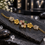 Gold-tone bracelet with multicoloured outer flower petals, clear teardrop-shaped inner petals, sculpted flowers and clear-accent tulip links.