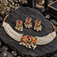 Gold-tone multicolour floral choker with white pearl-look bead strands, matching floral earrings and a coordinating ornament with hanging bead clusters.