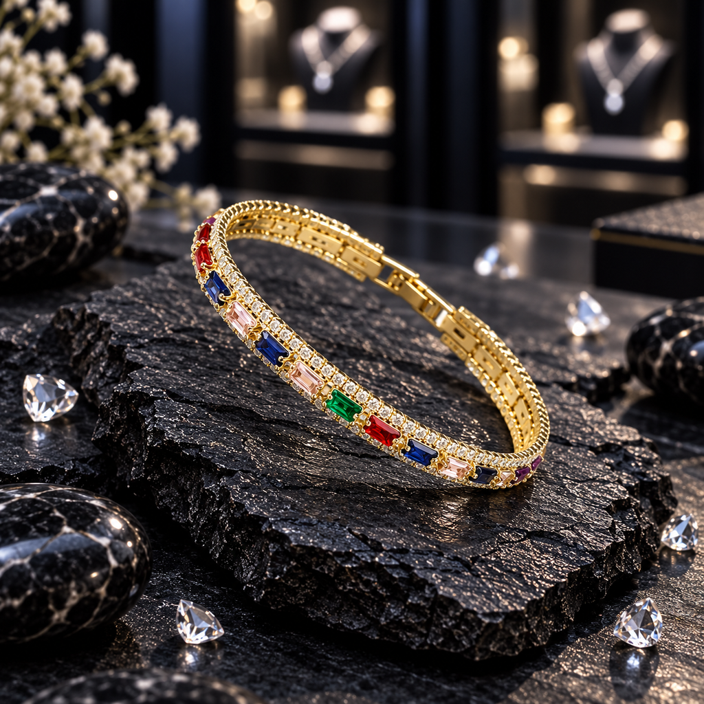 Single gold-tone bangle with blue, green, red, pale pink and purple rectangular accents, clear sparkling details and textured edging.