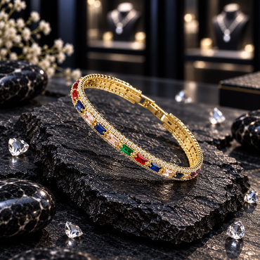 Single gold-tone bangle with blue, green, red, pale pink and purple rectangular accents, clear sparkling details and textured edging.