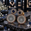 Gold-tone earrings with navy-blue cushion-shaped centres, clear-accent round disc drops and multicoloured borders.