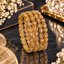 Ornate gold-tone bangles featuring clear teardrop-shaped and round accents.
