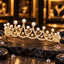 Gold-tone openwork tiara with overlapping clear-accent curved arches, cream-white round pearl-look tips and round clear details on thin stems, displayed on dark slate.