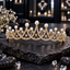 Gold-tone tiara with overlapping clear-accent arches, graduated peaks, white pearl-look beads and open fan-like details.