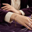 Gold-Tone Pink CZ Butterfly Adjustable Bracelet worn on wrist against purple velvet background