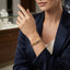 Gold-Tone Princess-Cut CZ Tennis Bracelet multi-color worn by model with navy blazer