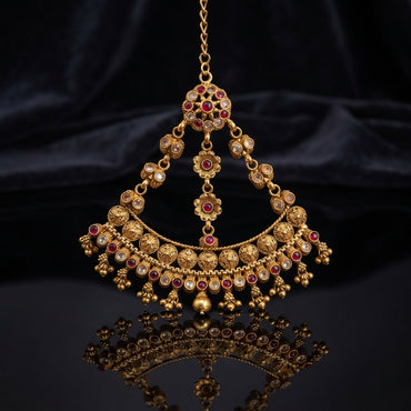 Gold-tone Rajwari jhummar with ruby red and white stone floral accents, coin medallions, and gold bead tassels