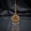 Gold-tone Rajwari bindiya with red and green accents, clear stones, and dangling white beads.