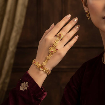 Gold-tone floral hathphool hand harness worn on a hand, showing the linked finger ring and wrist bracelet.