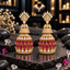 Pair of gold-tone tiered jhumka earrings with clear crown-like tops, sparkling upper bells and two rows of magenta teardrop accents.
