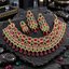 Gold-tone necklace with red oval centres, red-and-green square panels and red teardrop fringe, with matching long earrings and a smaller coordinating piece.
