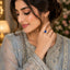 Gold-Tone Royal Blue Oval CZ Three-Stone Trilogy Bridal Ring worn by model in Pakistani grey formal attire